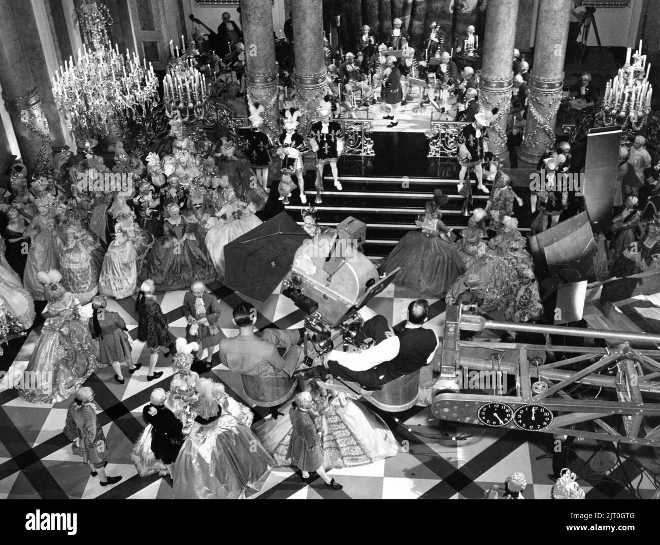 Camera Crew film overhead shots above the dancers on Versailles Ballroom Set on set candid during filming of MARIE ANTOINETTE 1938 director W.S. VAN DYKE cinematographer William H. Daniels art direction Cedric Gibbons gowns by Gilbert Adrian producer Hunt Stromberg Metro Goldwyn Mayer Stock Photo