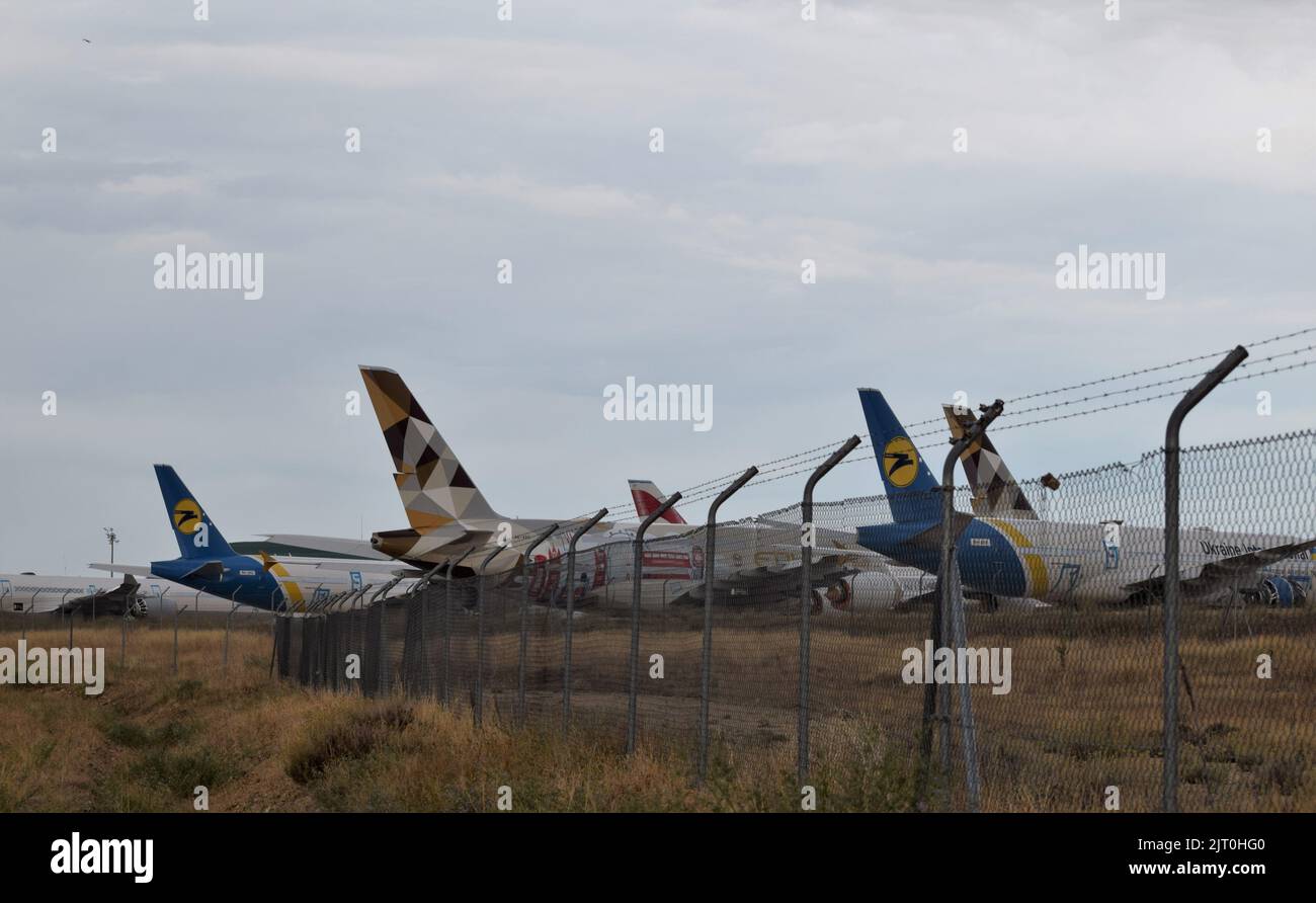 Teruel, España-25 de agosto de 2022: Valla   del desguace de aviones  con aviones esperando en la pista cerca de la valla metálica. Stock Photo