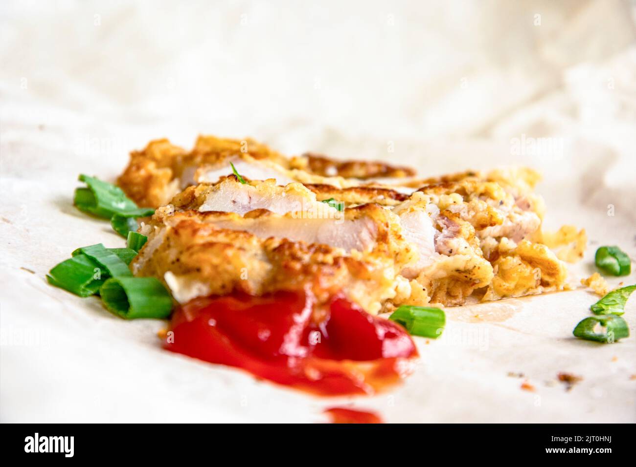 Fresh fried pork chops sprinkled with green onions and ketchup