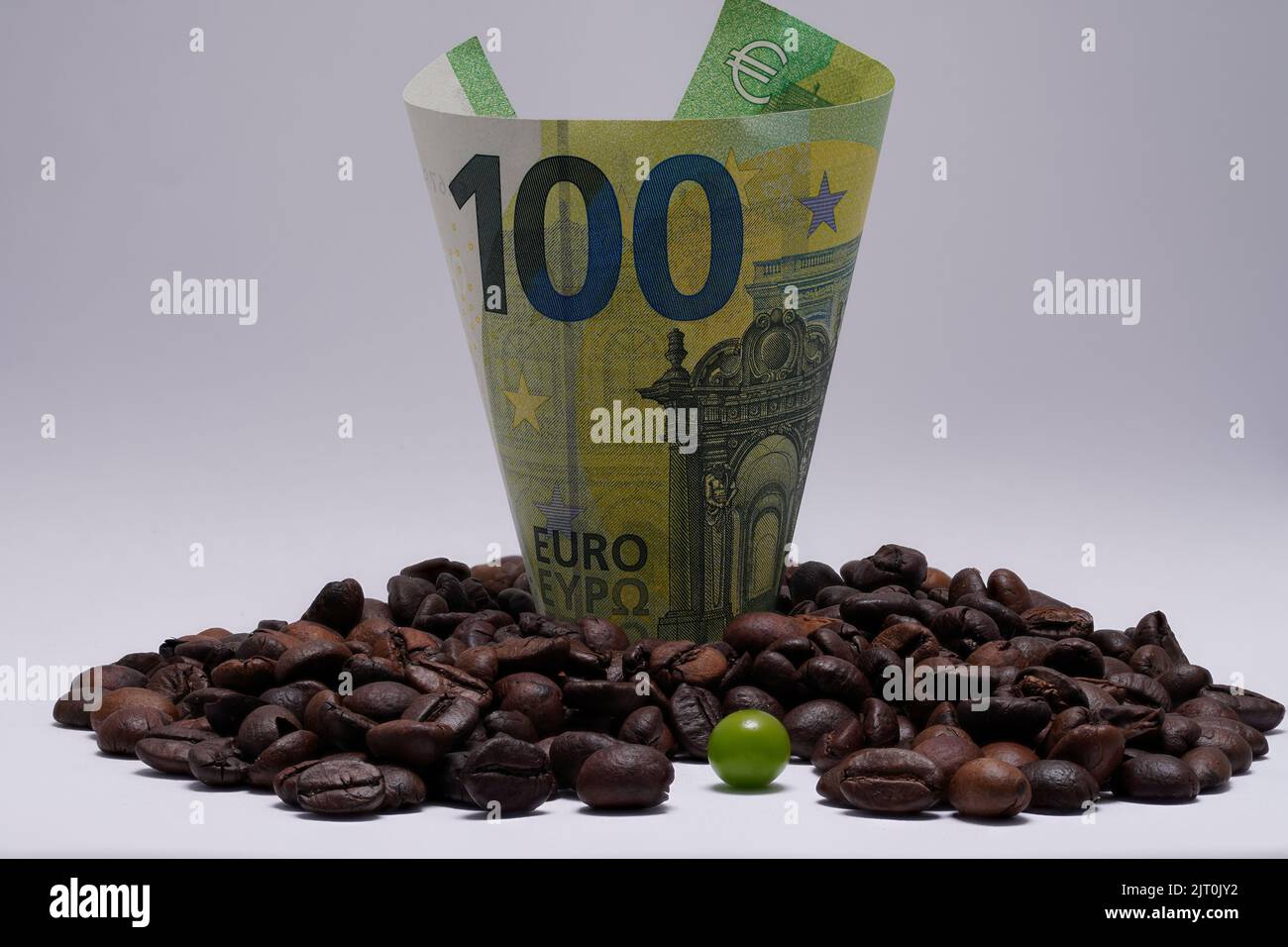 one hundred euros among coffee beans Stock Photo