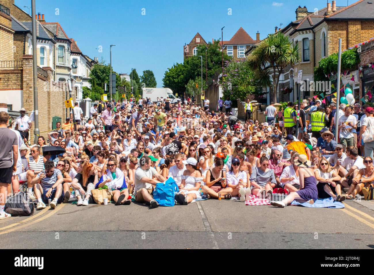 Crowds watch the Wimbledion Tennis final outside on a big screen in Northcote Road, London Stock Photo