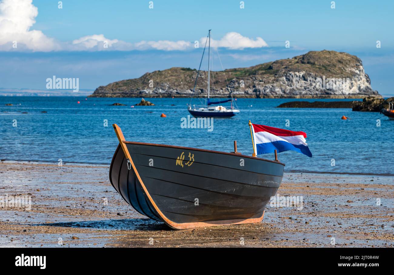North Berwick, East Lothian, Scotland, UK, 27th August 2022. Coastal Rowing Regatta: the seaside town hosts the annual regatta in the Firth of Forth on a beautiful sunny day with teams from clubs around the East of Scotland, England and even one team from The Netherlands (pictured). Credit: Sally Anderson/Alamy Live News Stock Photo