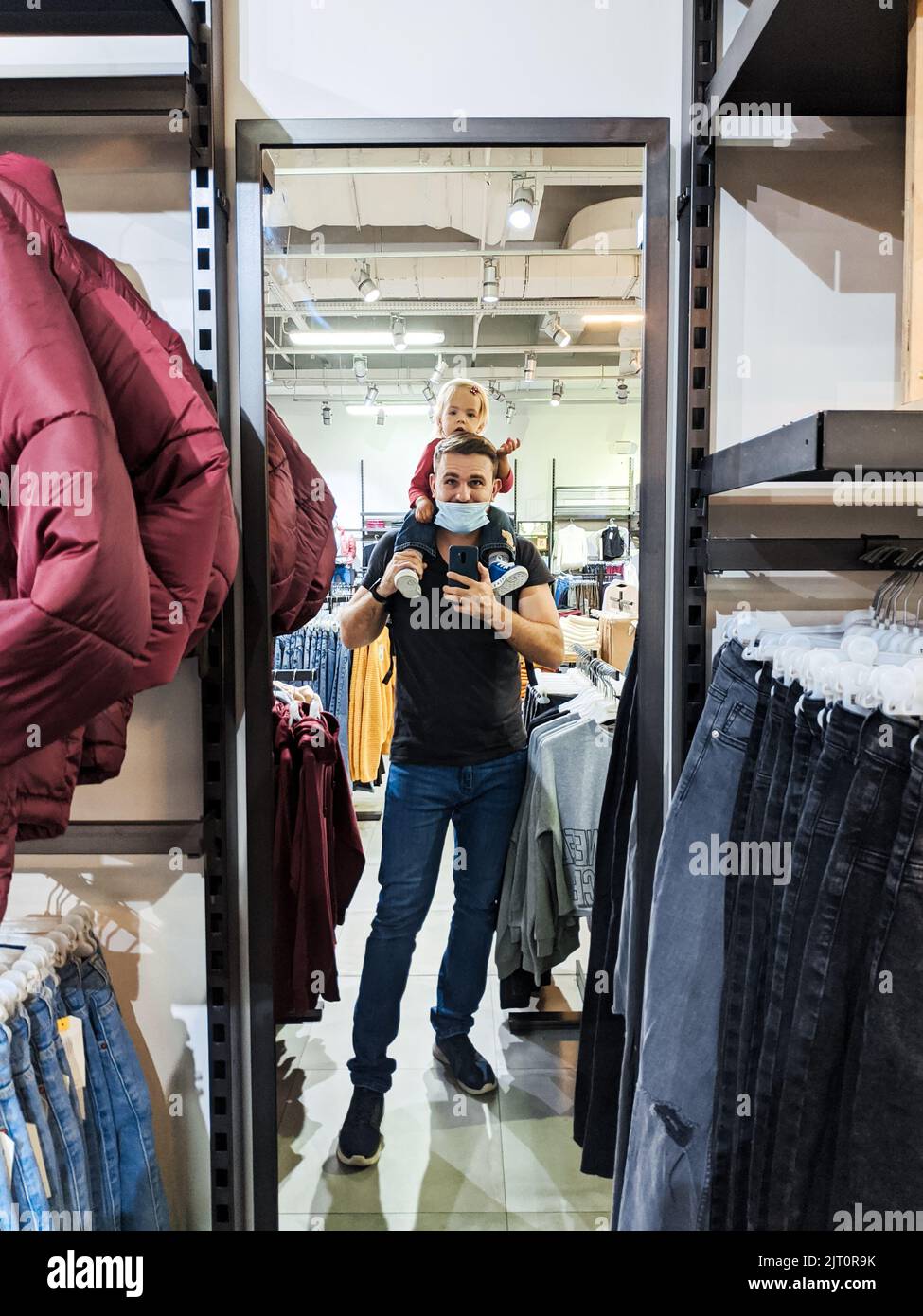 Budva, Montenegro - 07.07.22: Dad with a little girl on his shoulders