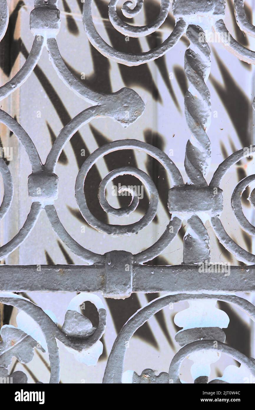 Ornate iron metal entry gate with swirls for decoration in a bright ...