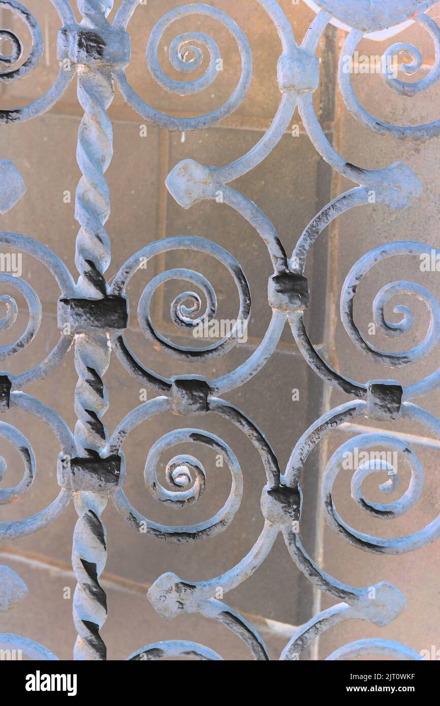 Ornate iron metal entry gate with swirls for decoration in a bright ...