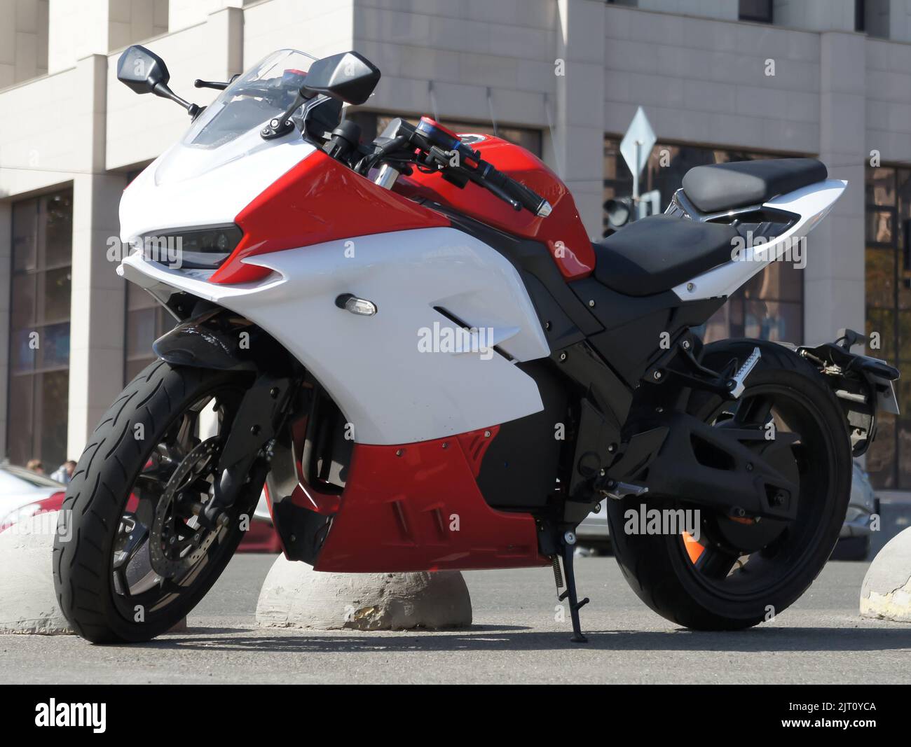 Red white italian sportbike on the street. Beautiful motorcycle in the