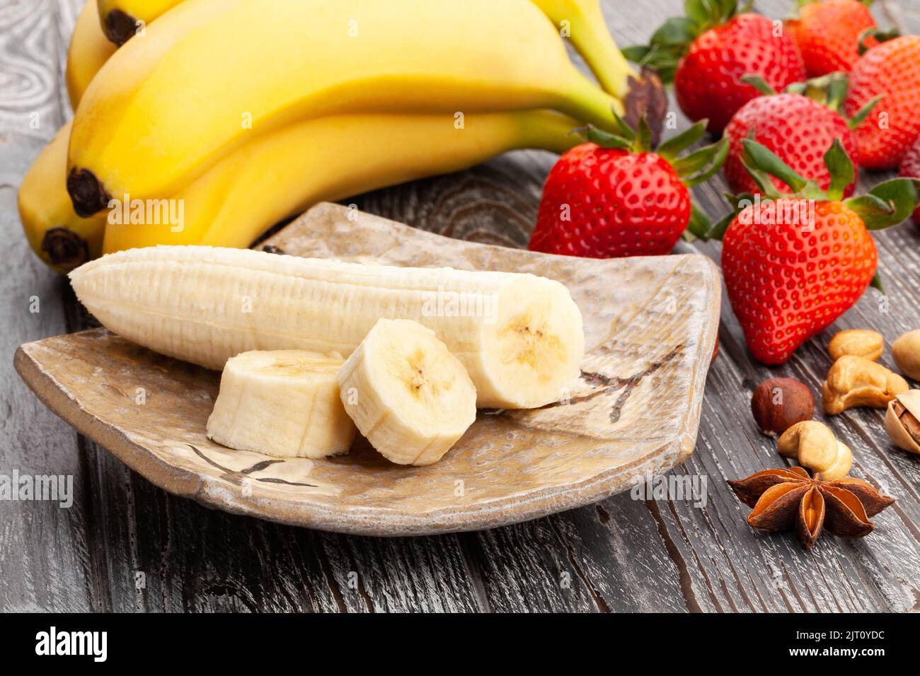 sliced banana on wood background Stock Photo
