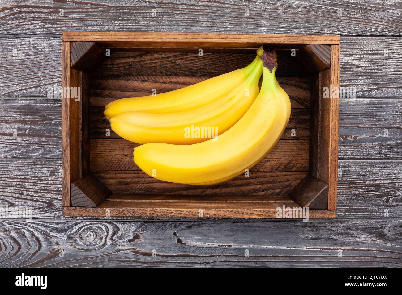 banana in box on wood background Stock Photo