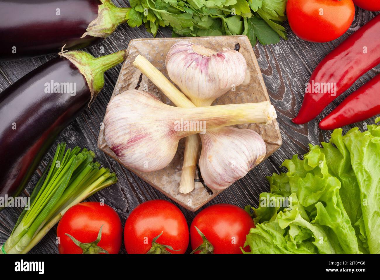 garlic on a plate on wood background Stock Photo