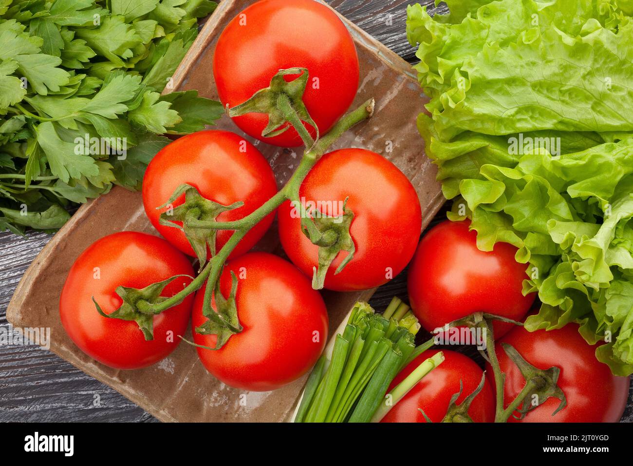 tomato on a plate on wood background Stock Photo