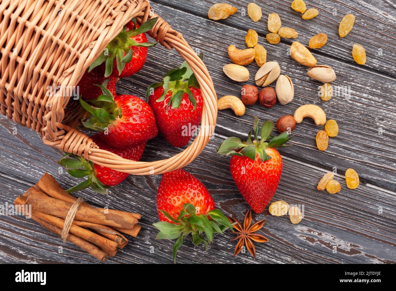 strawberry in a basket on wood background Stock Photo - Alamy
