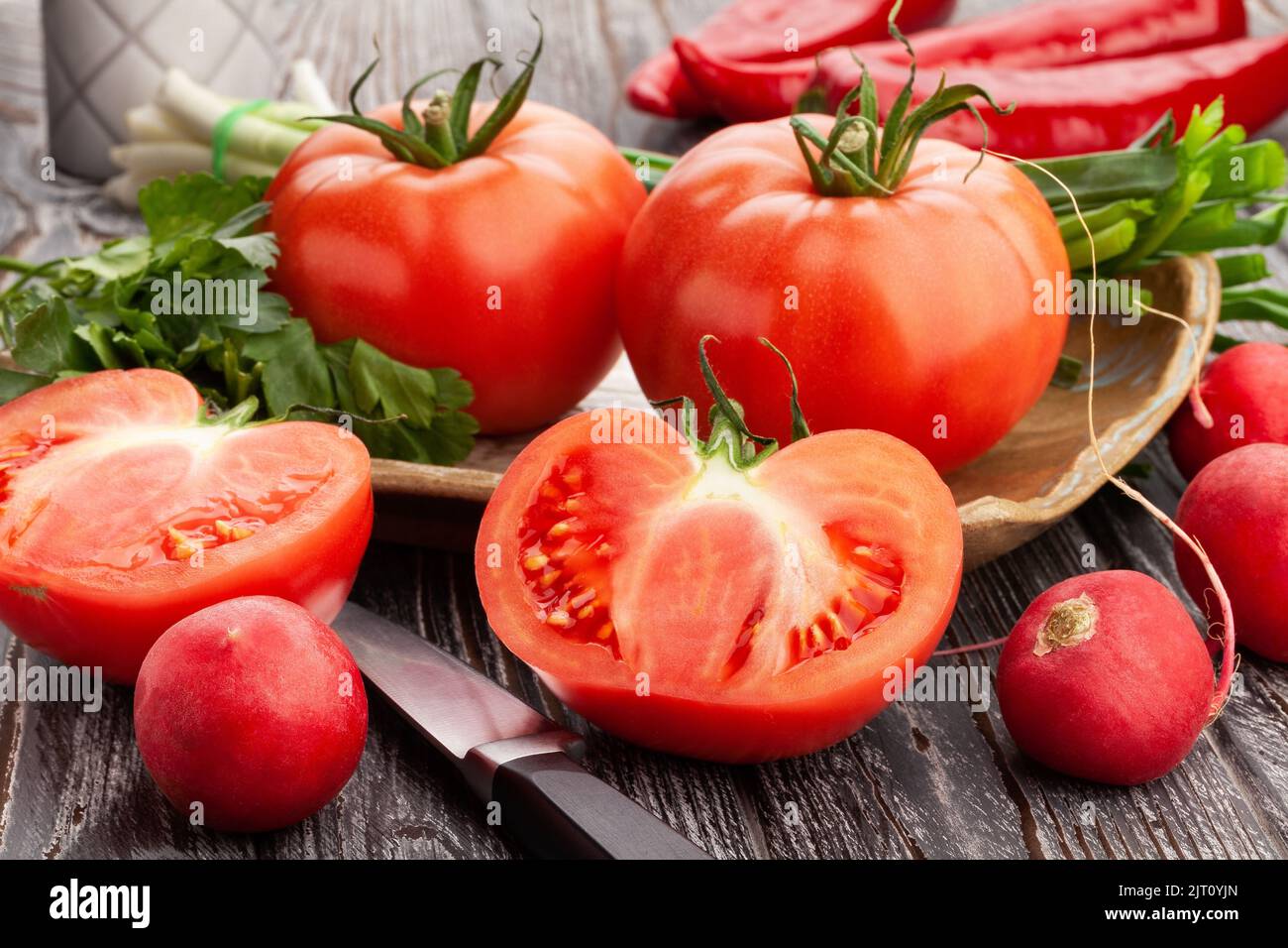 sliced tomato on wood background Stock Photo