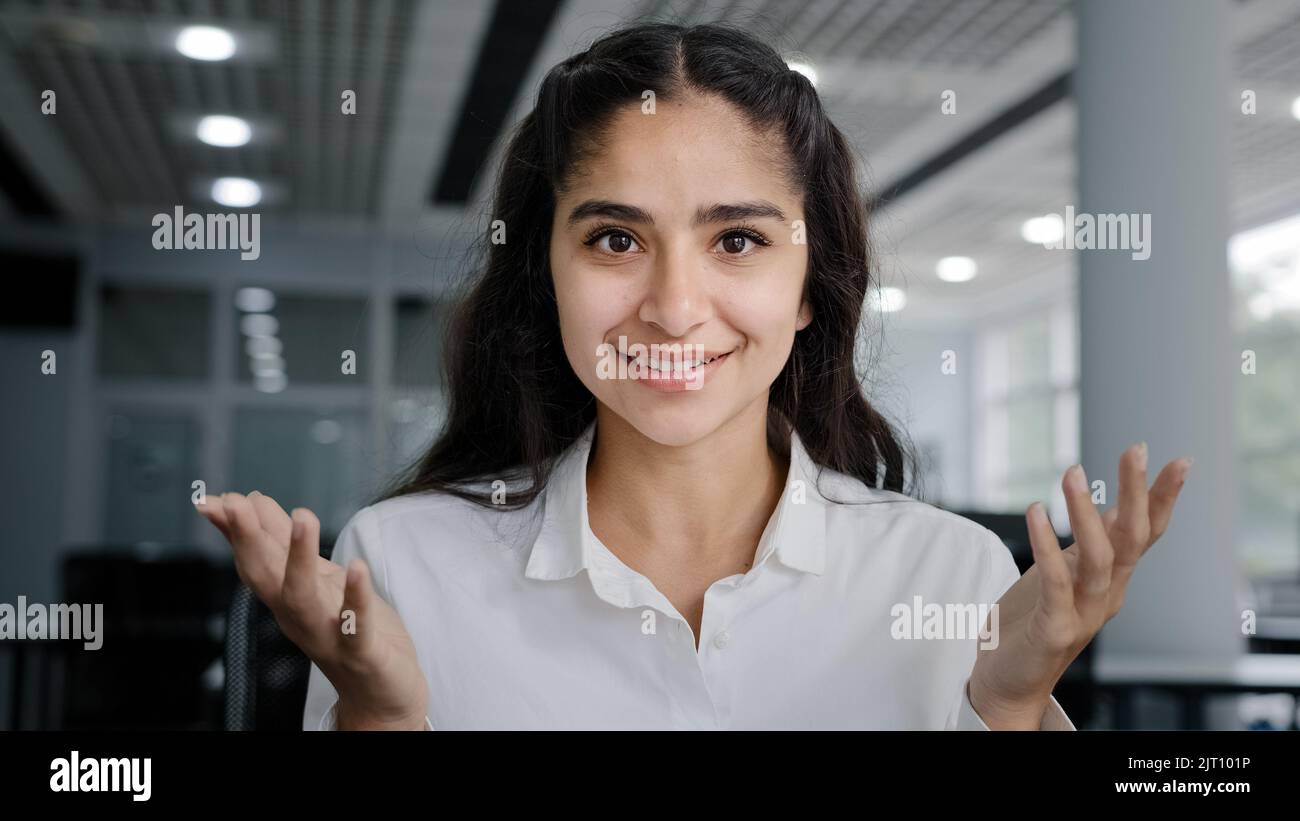 Headshot young positive woman business agent sales consultant makes presentation looking at camera talking using webcam sells product advertises Stock Photo