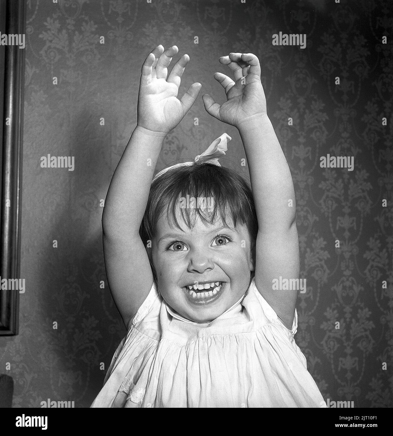 Girl in the 1950s. A charming and laughing girl is looking at the