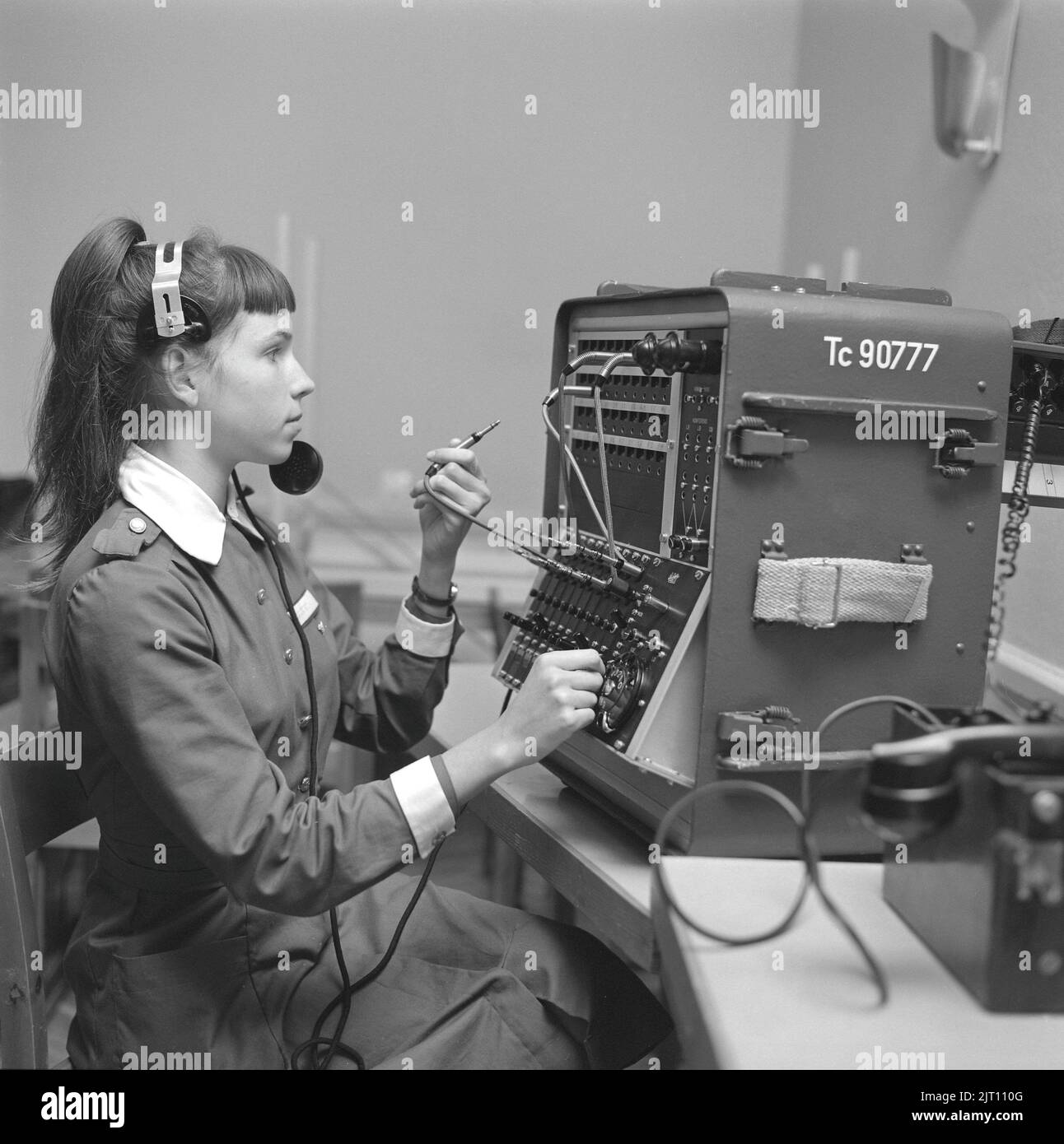 Women part of the Swedish home guard practising 1962. Lottorna is an auxiliary defence organization of the Swedish Home Guard, a part of the Swedish Armed Forces. Picture shows a girl at the switchboard of incoming outgoing calls and messages during the military practice. Stock Photo