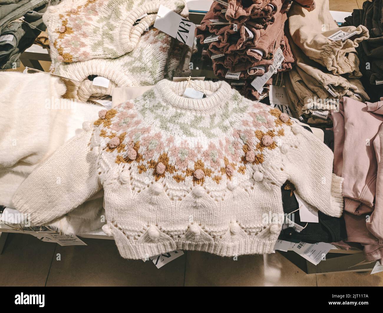 budva-montenegro-010822-children-knitted-sweater-lies-on-a-shelf-in-a-clothing-store-2JT117A.jpg