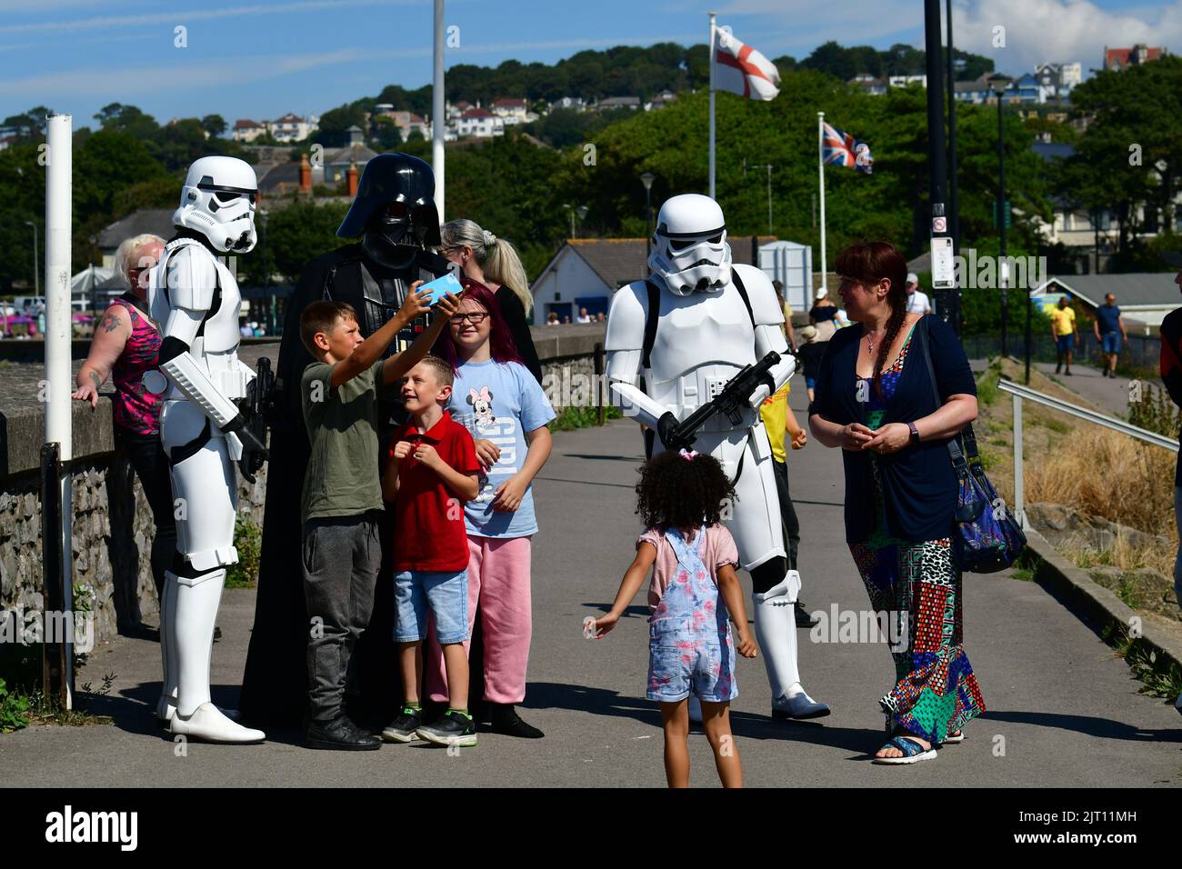 Clevedon, UK. 27th Aug, 2022. ON a very hot afternoon at Clevedon North Somerset Bank Holiday Weekend, Star Wars Stormtroopers are seen walking along the seafront stopping for selfies with visitors taking pictures of themselves and children. Storm Troopers are Raising money for Childrens Hospice. Picture Credit: Robert Timoney/Alamy Live News Stock Photo