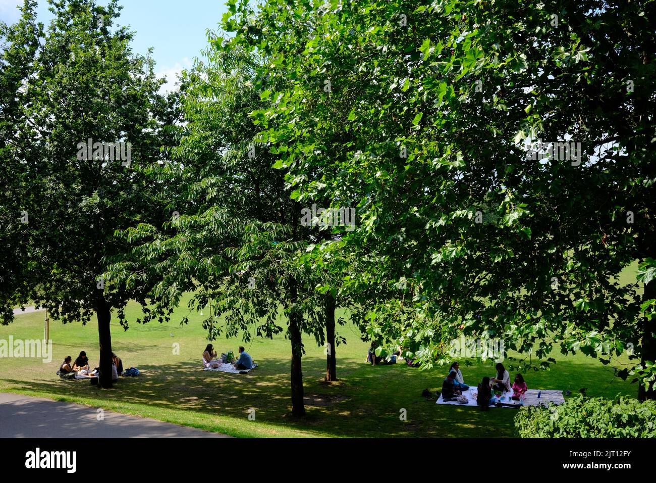 Saltaire, Roberts Park, people sitting on the grass, Yorkshire Stock Photo