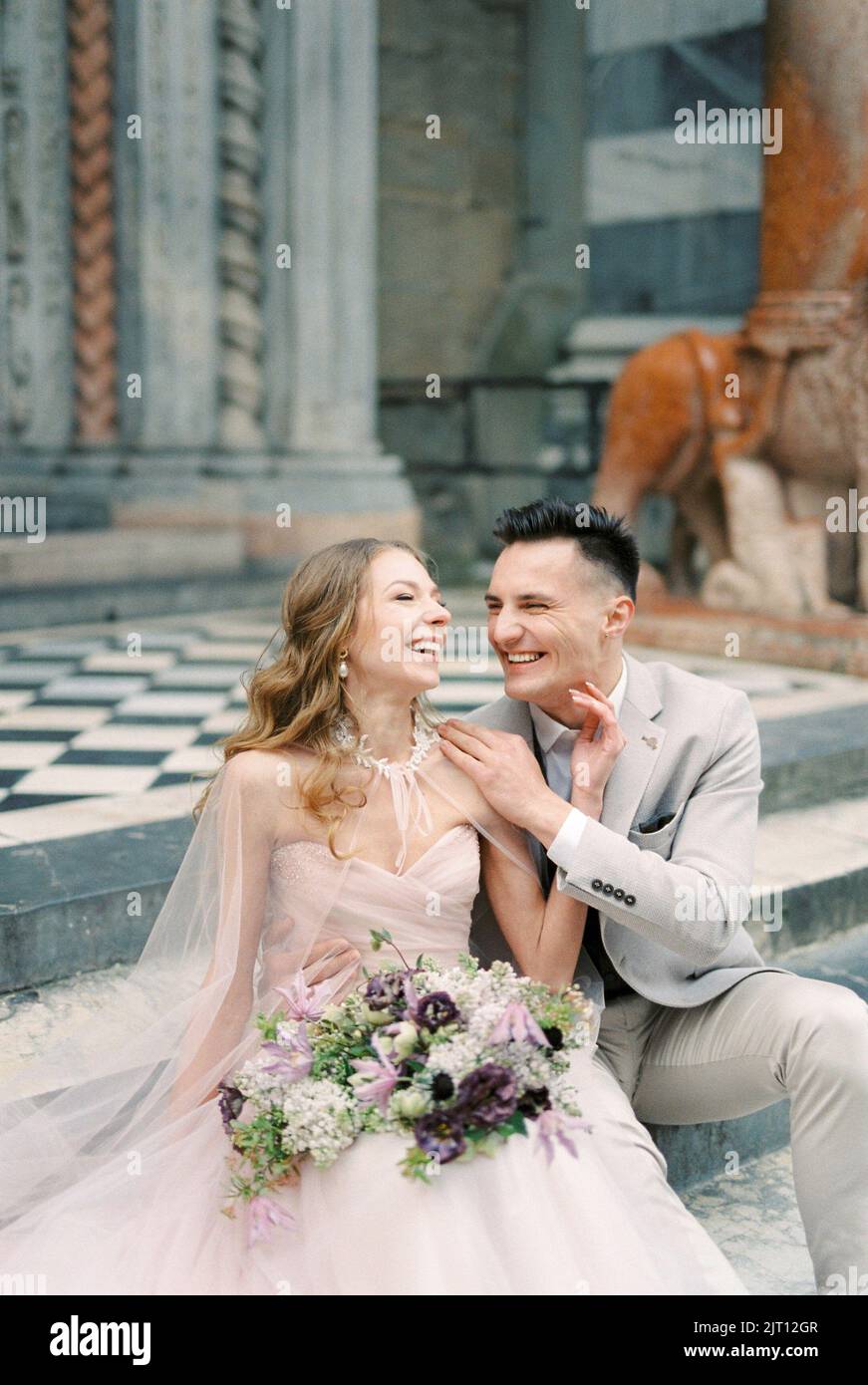 Bride sitting on steps bouquet hi-res stock photography and images - Alamy