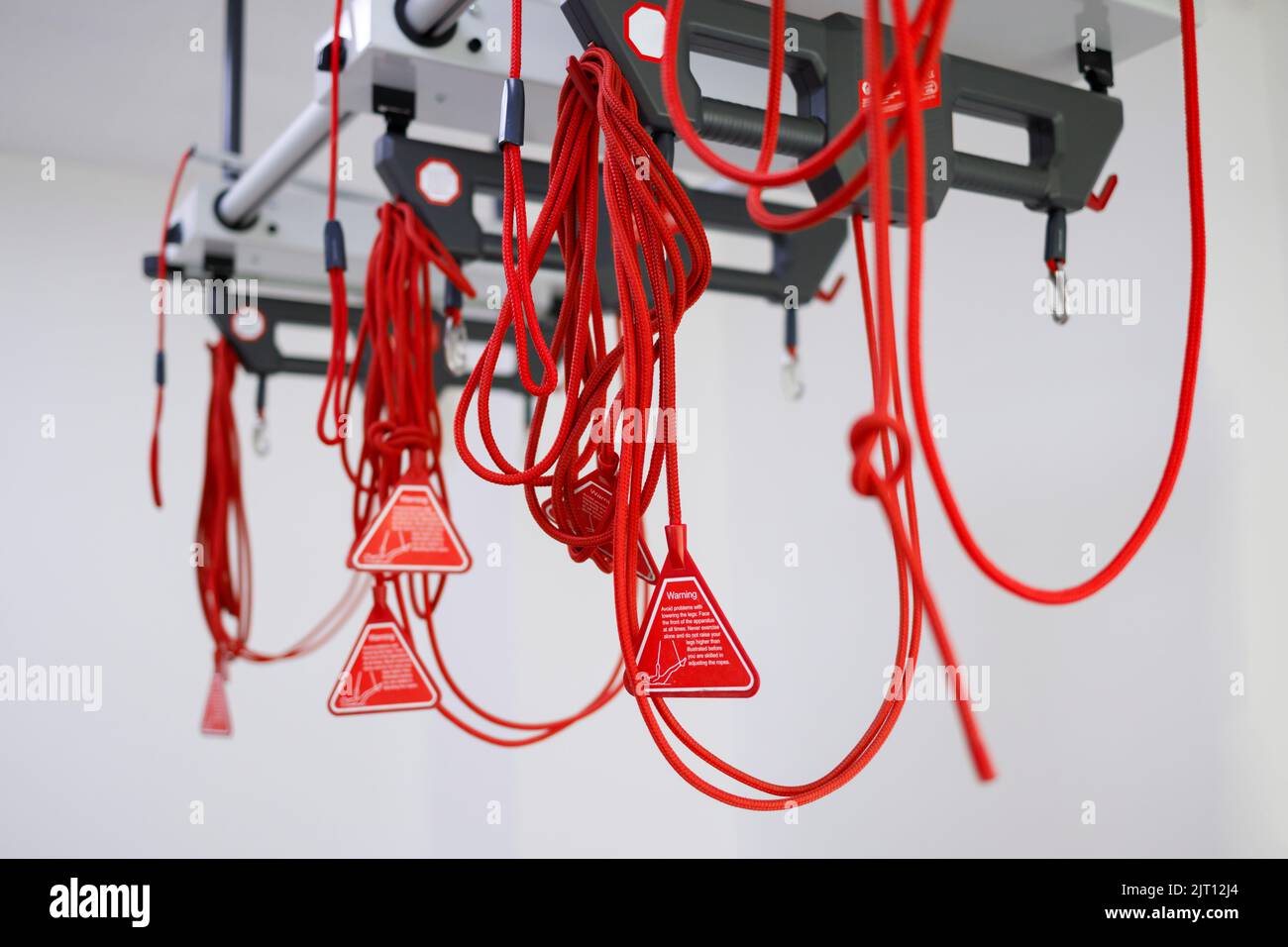 Pilates studio with red cord suspension therapy system. Training