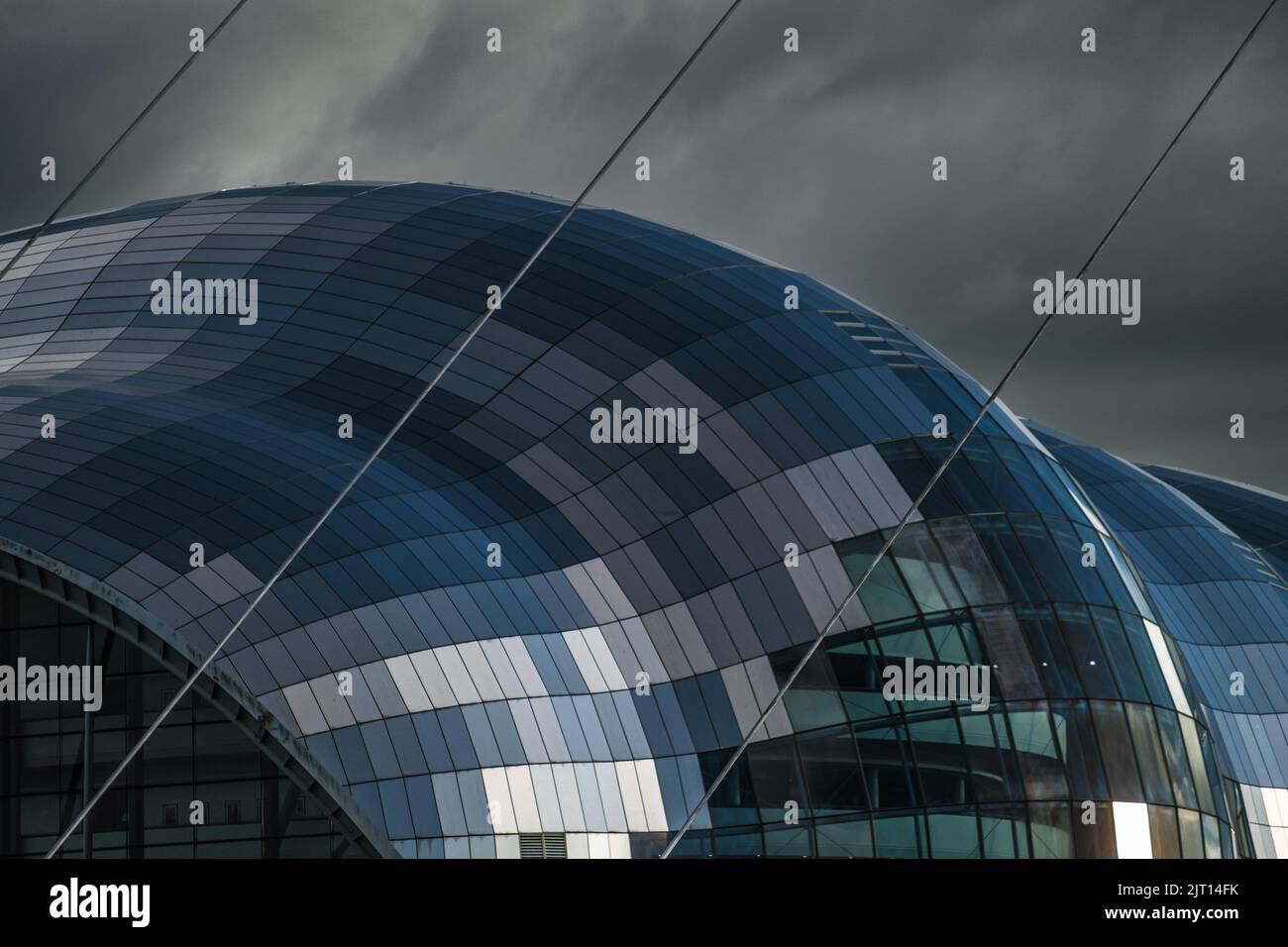 The curves of the Sage Gateshead against the cloudy sky Stock Photo
