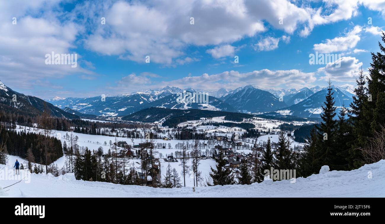 Beautiful aerial panorama view of Ramsau am Dachstein village and Schladming with Planai and other peaks of Alps in background with blue sky cloud in Stock Photo