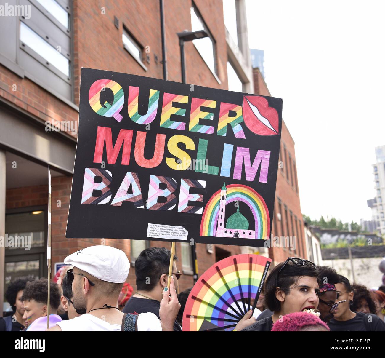 Manchester, UK. 27th August, 2022. Group with 'Queer Muslim' placard. Participants get ready to take part in the LGBTQ+ Pride parade, central Manchester, UK, as LGBTQ+ Pride continues over the Bank Holiday weekend 26th to 29th August. Organisers say: 'Manchester Pride is one of the UK's leading LGBTQ+ charities. Our vision is a world where LGBTQ+ people are free to live and love without prejudice. We’re part of a global Pride movement celebrating LGBTQ+ equality and challenging discrimination.' Credit: Terry Waller/Alamy Live News Stock Photo