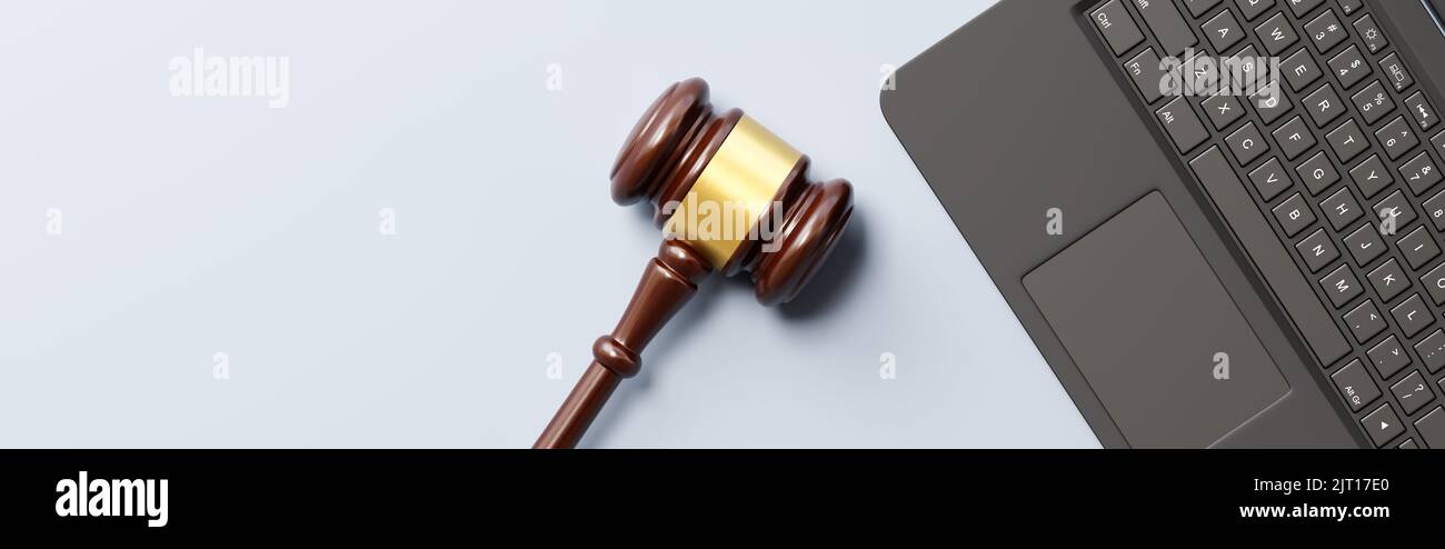 Judge's Gavel and Laptop Computer on Gray Background with Copy Space Stock Photo