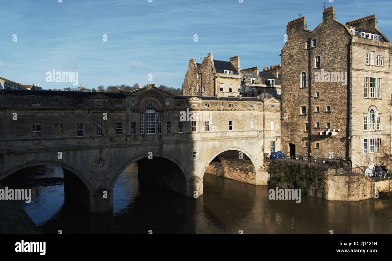 An outdoor view of old buildings and the Pulteney Bridge over a river