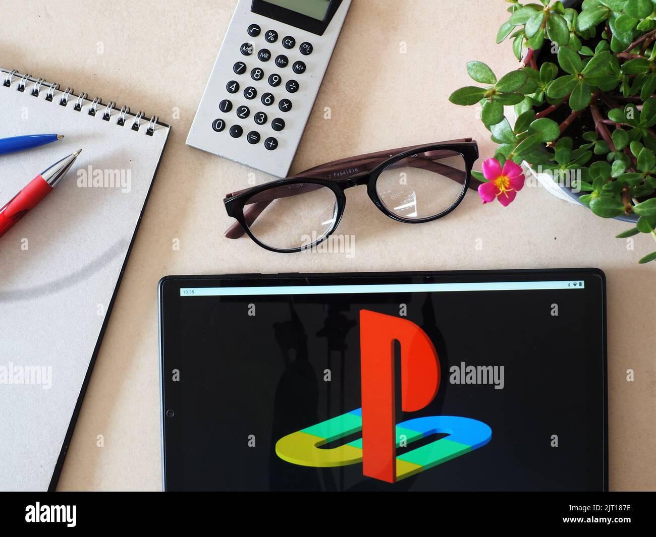 In this photo illustration,  PlayStation logo seen displayed on a tablet Stock Photo