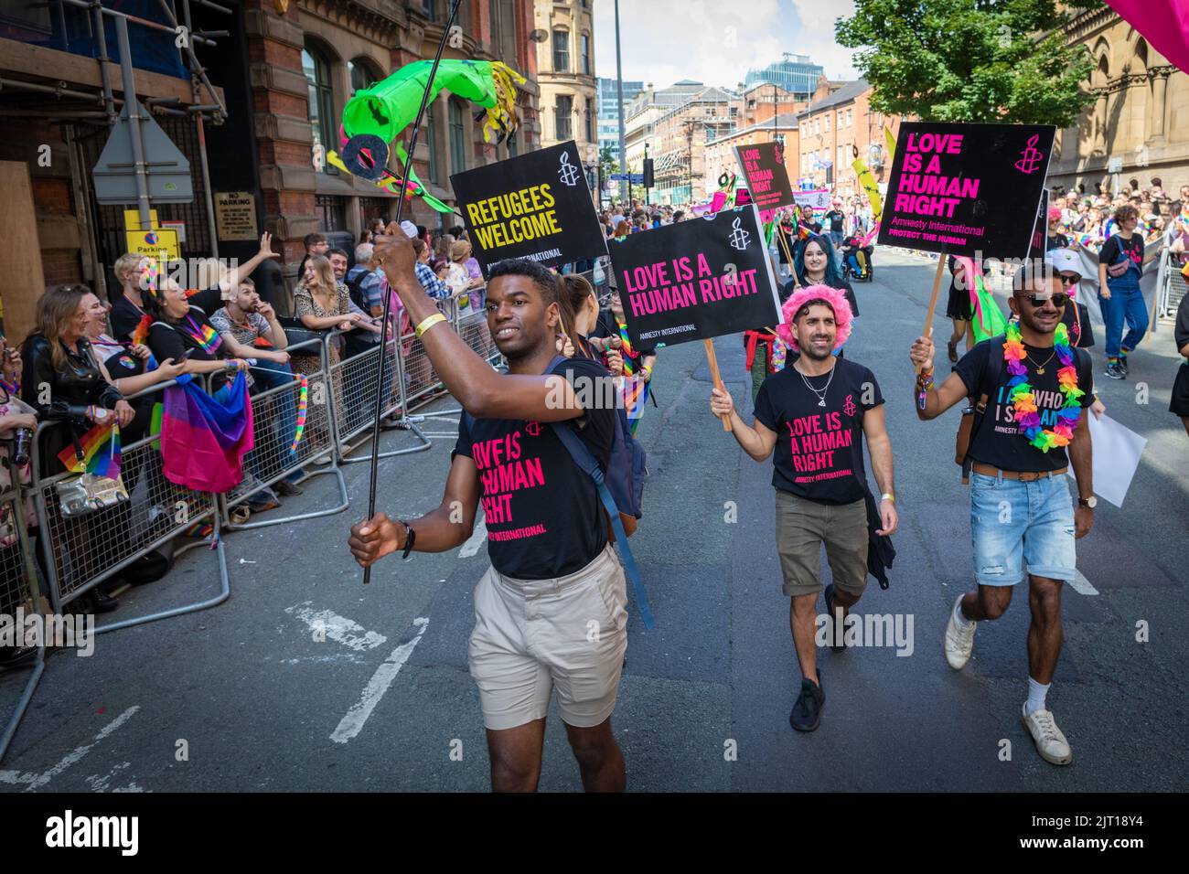 Manchester, UK. 27th Aug, 2022. The LGBTQIA  community come together with banners and during the Pride Parade. This year sees the parade come back at full capacity for the first time since 2019. Credit: Andy Barton/Alamy Live News Stock Photo