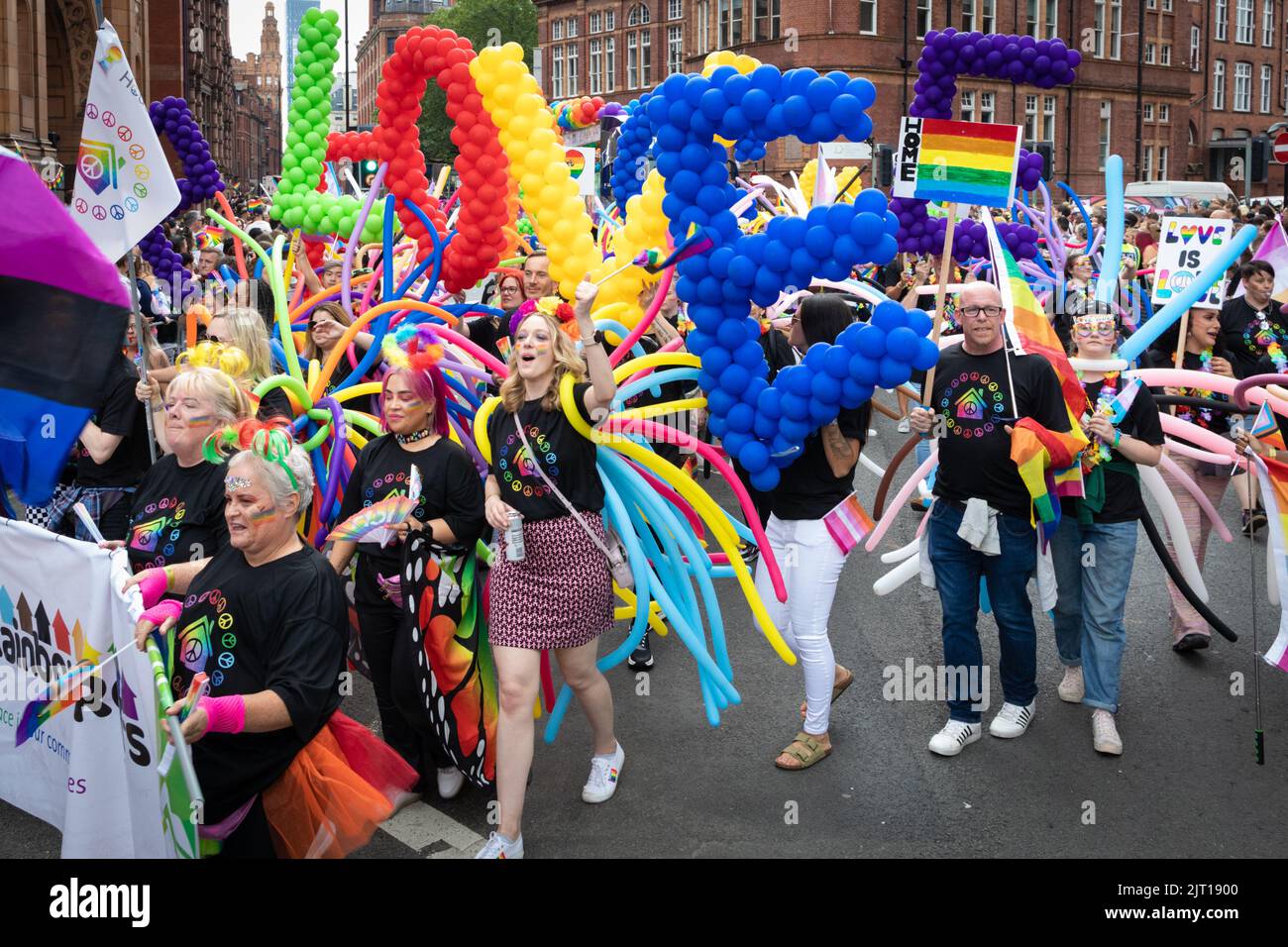 Manchester, UK. 27th Aug, 2022. The LGBTQIA  community come together with banners and flags during the Pride Parade. This year sees the parade come back at full capacity for the first time since 2019. Credit: Andy Barton/Alamy Live News Stock Photo