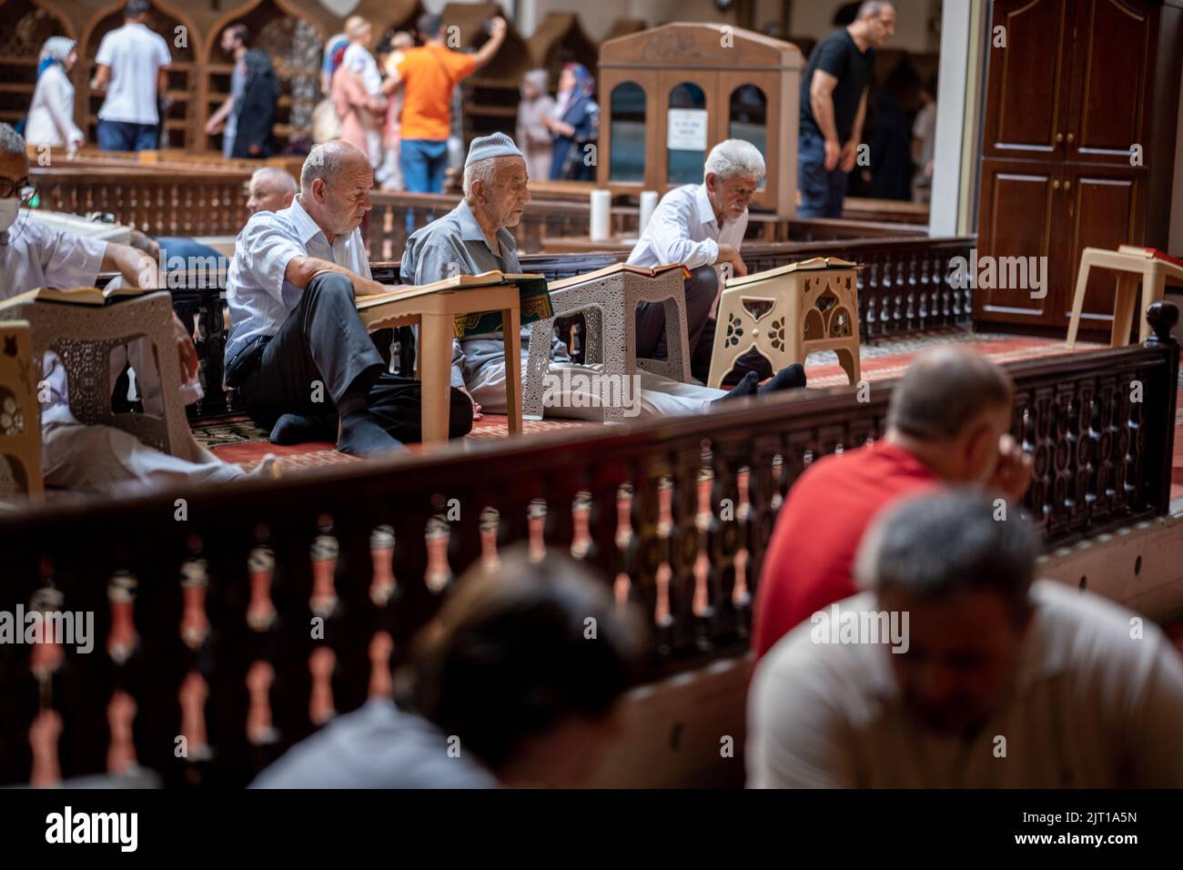 BURSA, TURKEY - AUGUST 21: An interior view of Grand Mosque (Ulu Cami) on August 21, 2022 in Bursa, Turkey. Muslims reciting the Quran inside the mosq Stock Photo