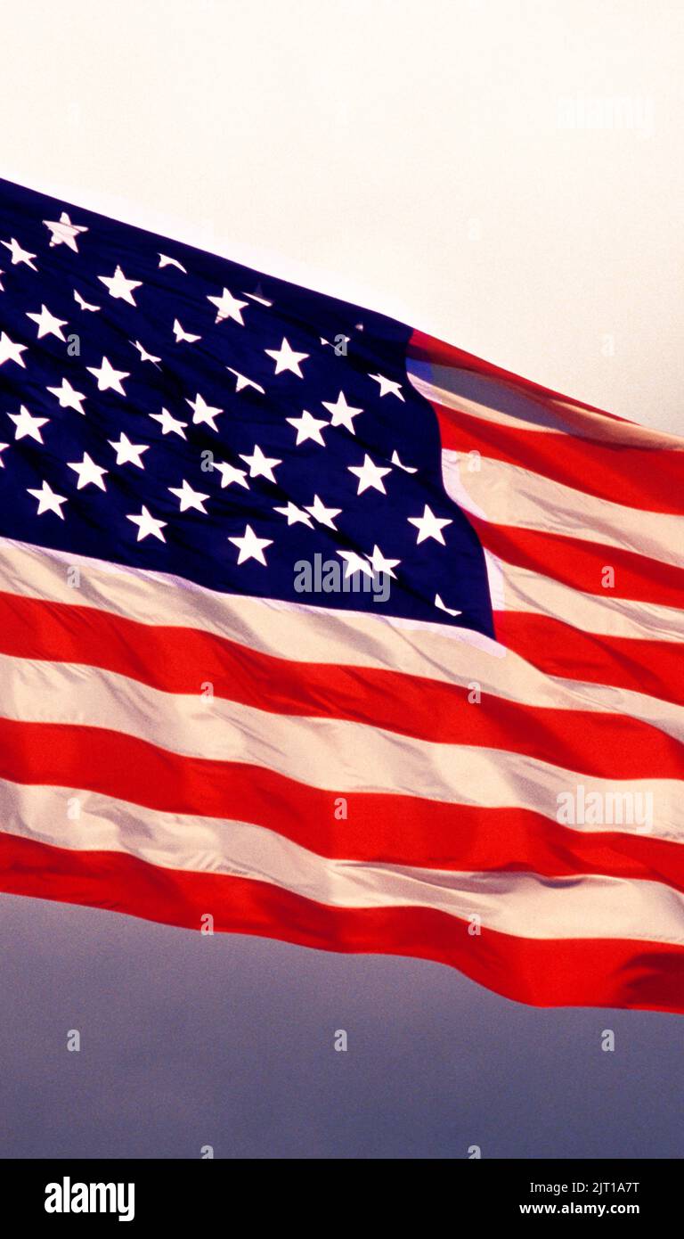 American flag flying. Vertical Stock Photo