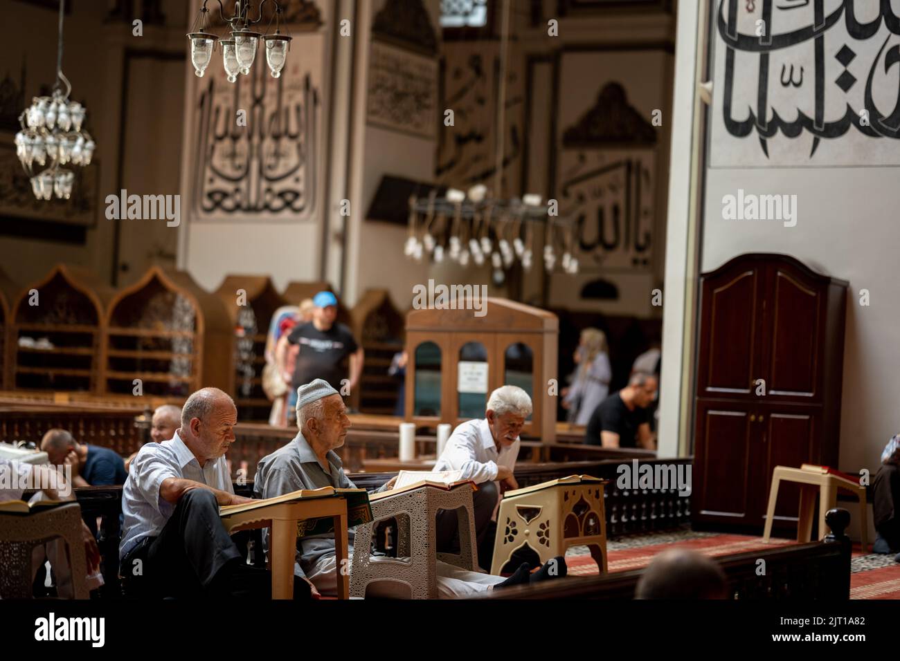 BURSA, TURKEY - AUGUST 21: An interior view of Grand Mosque (Ulu Cami) on August 21, 2022 in Bursa, Turkey. Muslims reciting the Quran inside the mosq Stock Photo