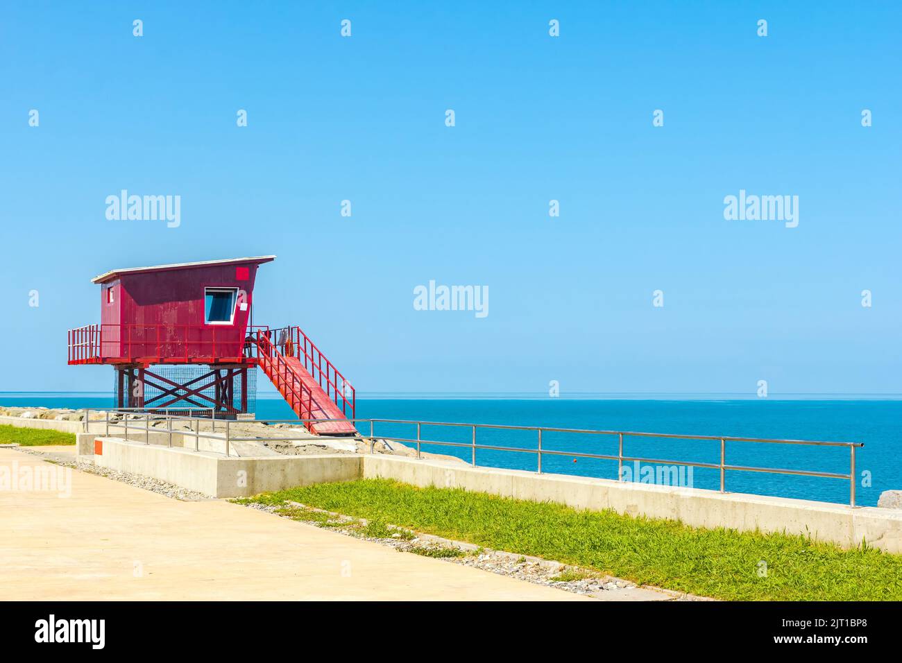 Red rescue box on the seashore in sunny weather Stock Photo