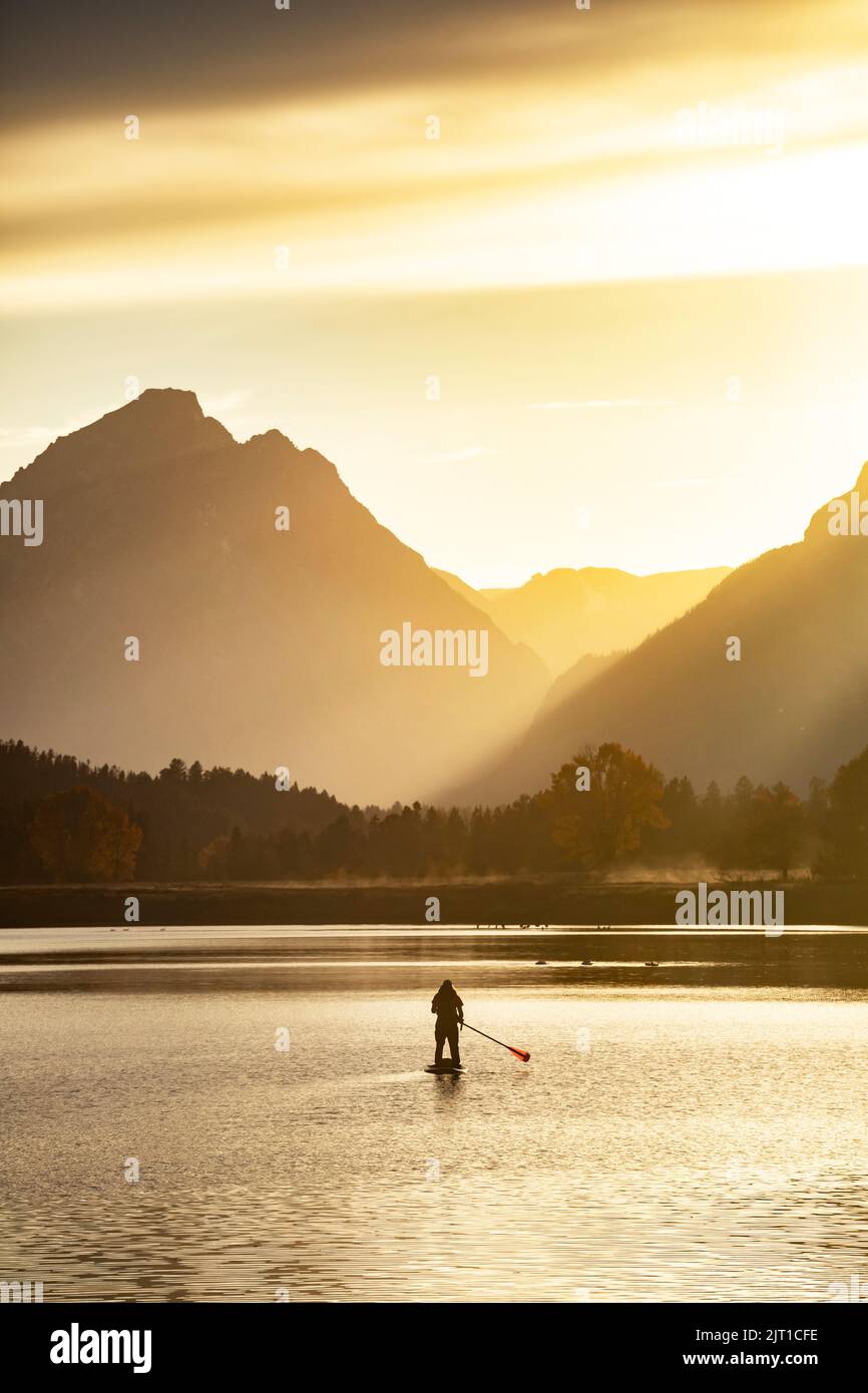 WY04997-00.....WYOMING - Paddle boarder on the Snake River at the Ox Bow in Grand Teton National Park. Stock Photo