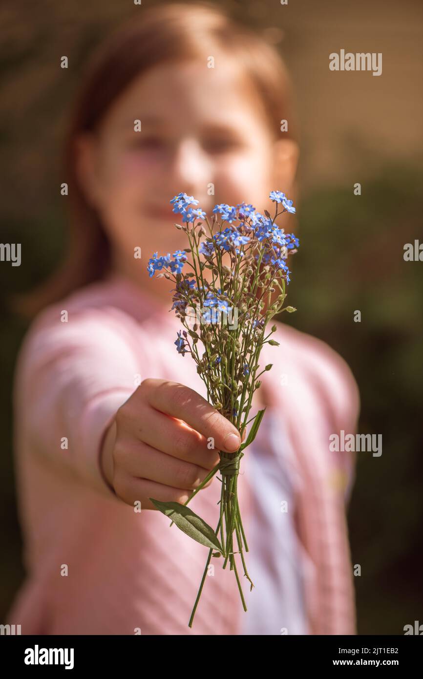 a girl holds out a bouquet of Stock Photo Alamy