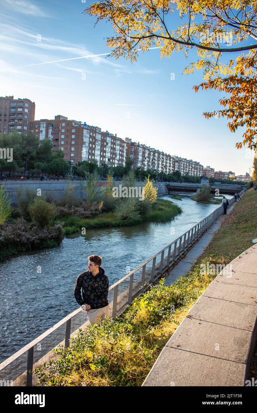 Handsome caucasian man looking away next to the river Stock Photo