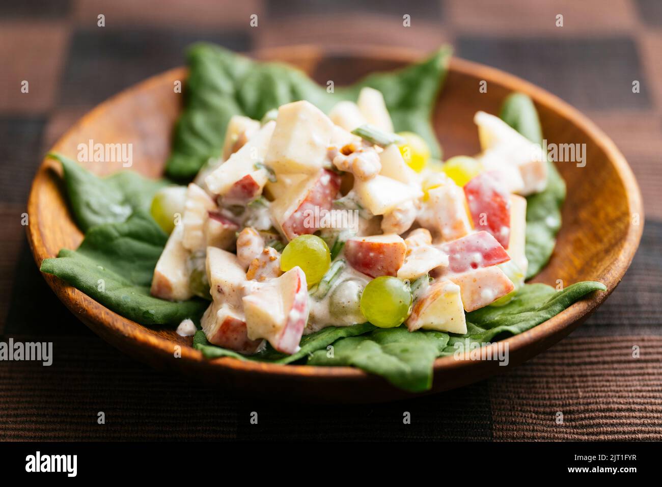 Traditional waldorf salad with a vegan dressing on New Zealand spinach. Stock Photo