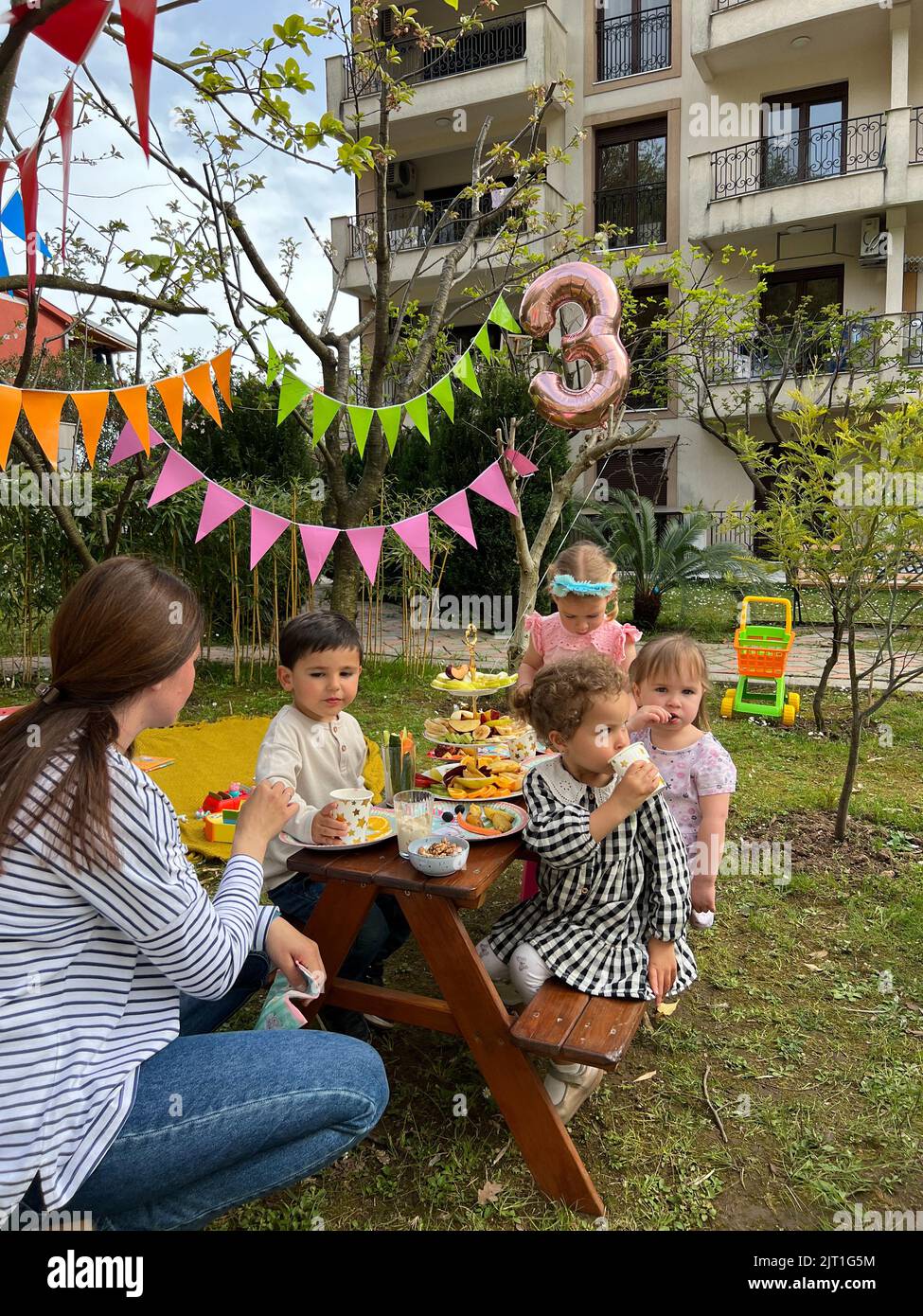 Budva, Montenegro - 01.08.22: Woman is sitting next to the children at