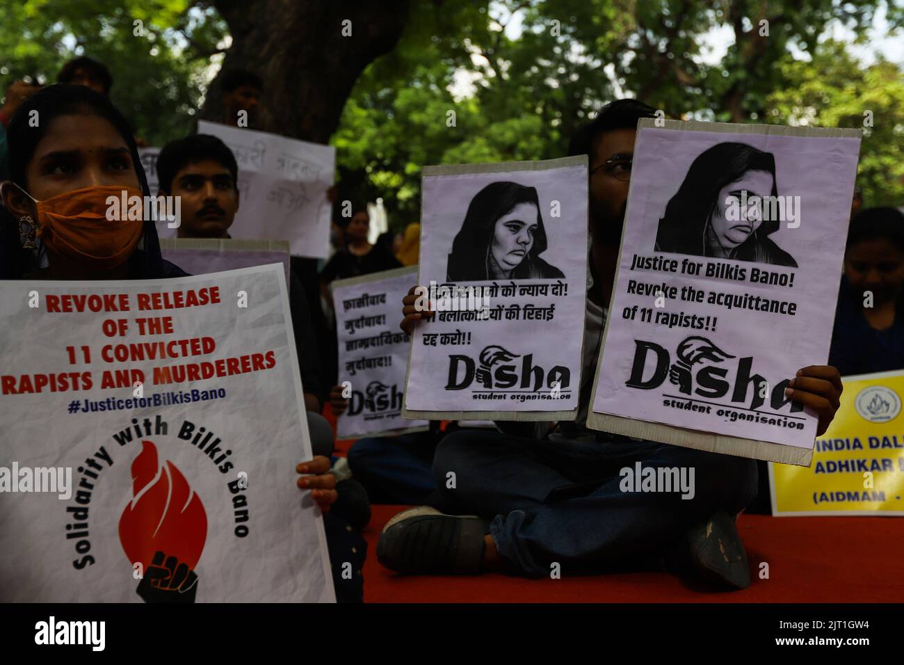 New Delhi, India. 27th Aug, 2022. Demonstrators hold placards during a protest against the release of a group of convicts who had gang raped Bilkis Bano during the 2002 communal riots in Gujarat from jail following a recommendation by a Gujarat state government panel in New Delhi. Bano, who was gang-raped while 14 others were brutally murdered in one of post-independent India's worst religious riots, said that she was 'numb' after learning about the early release of the convicts. Credit: SOPA Images Limited/Alamy Live News Stock Photo