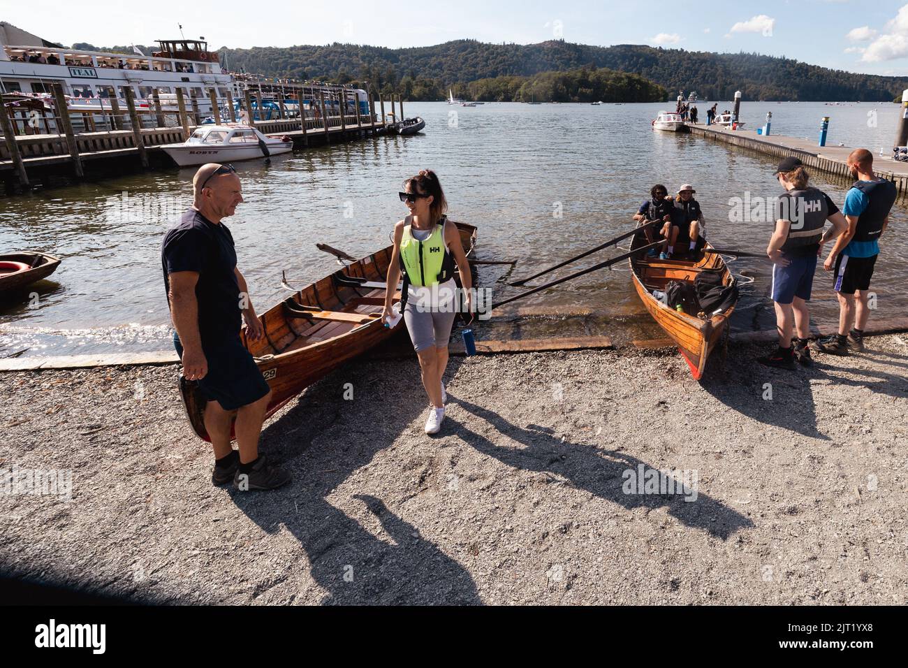Lake Windermere Cumbria 27th August 2022 .UK Weather Vessels of all sizes & age busy with tourist make the most of the Bank Holiday weekend weather Traditional Windermere wooden Rowing Boats . Credit: Gordon Shoosmith/Alamy Live News Stock Photo