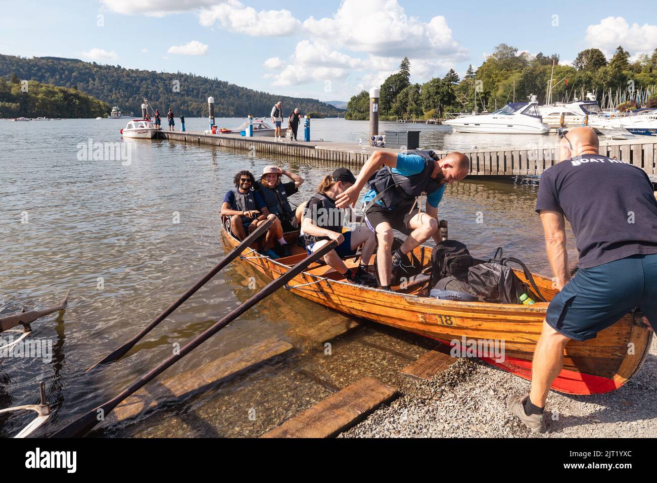 Lake Windermere Cumbria 27th August 2022 .UK Weather Vessels of all sizes & age busy with tourist make the most of the Bank Holiday weekend weather Traditional Windermere wooden Rowing Boats . Credit: Gordon Shoosmith/Alamy Live News Stock Photo