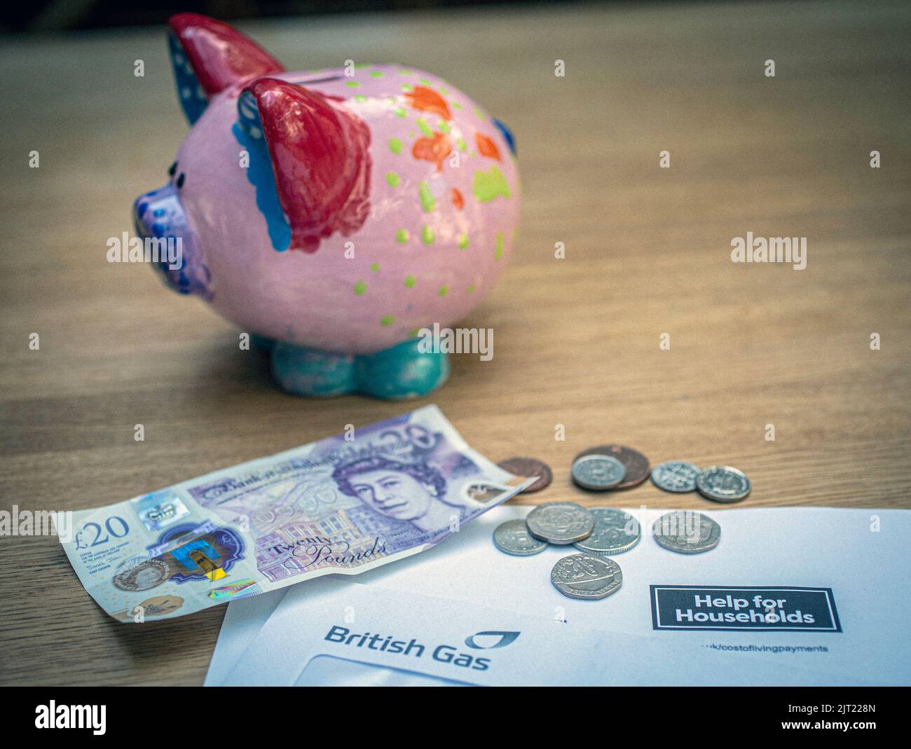 British £20 note and coins on HM Government letter notifying of UK government household help, United Kingdom Stock Photo