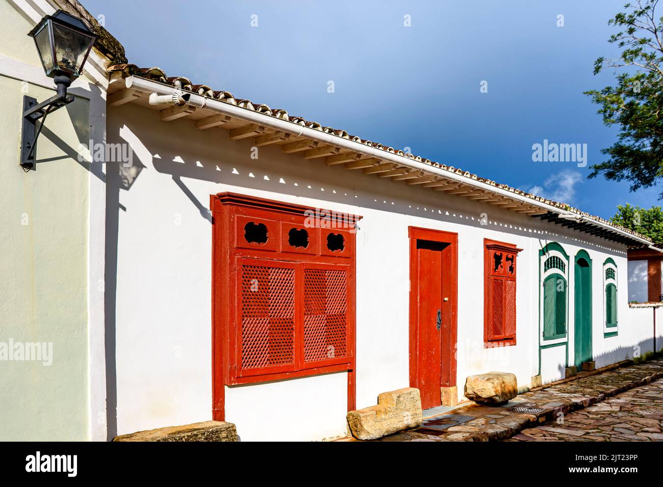 Street with ancient colonial style houses with colorful doors and windows in the historic city of Tiradentes in Minas Gerais, Brazil Stock Photo