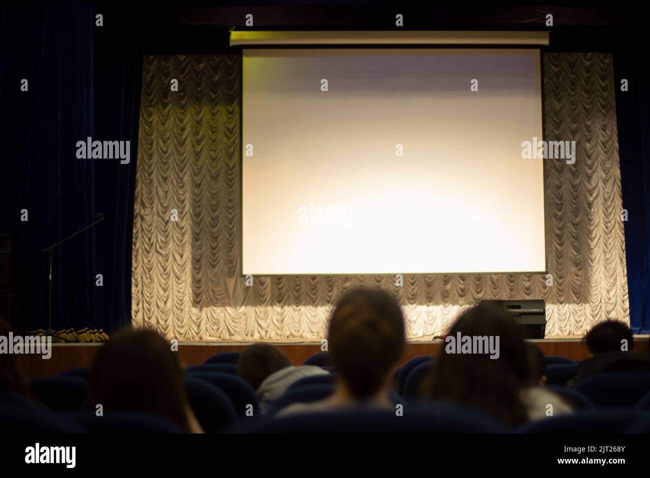 Screen for projector. Auditorium. White screen for image projection