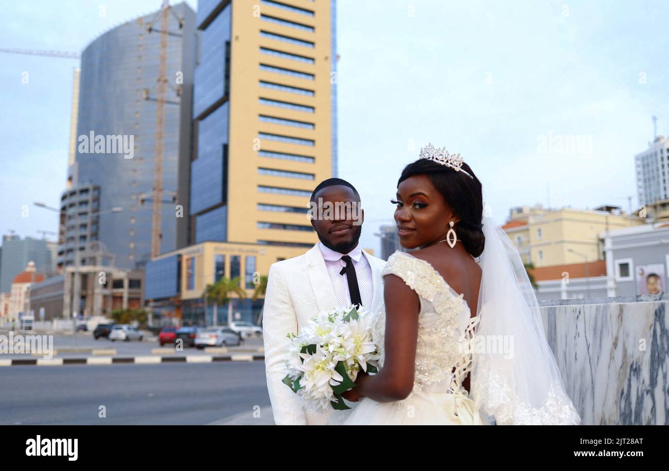 Orlando and Azira Lourenco, a bride and groom, look on during their wedding in the city center of Luanda, Angola, August 27, 2022. REUTERS/Siphiwe Sibeko Stock Photo