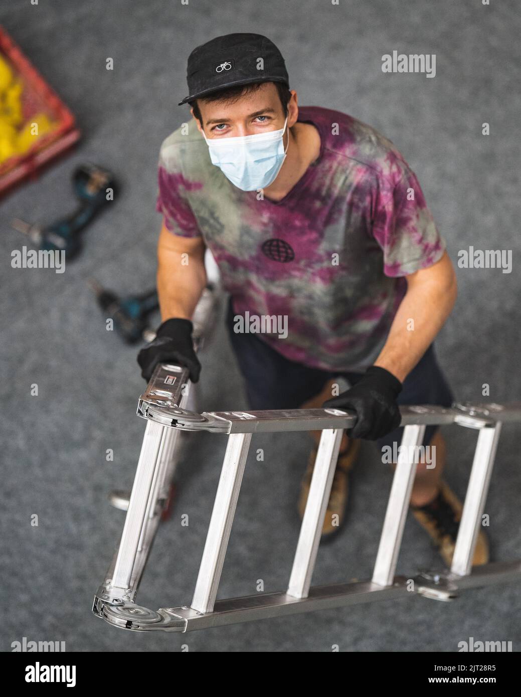 A climbing route setter trying to set a route in the bouldering gym