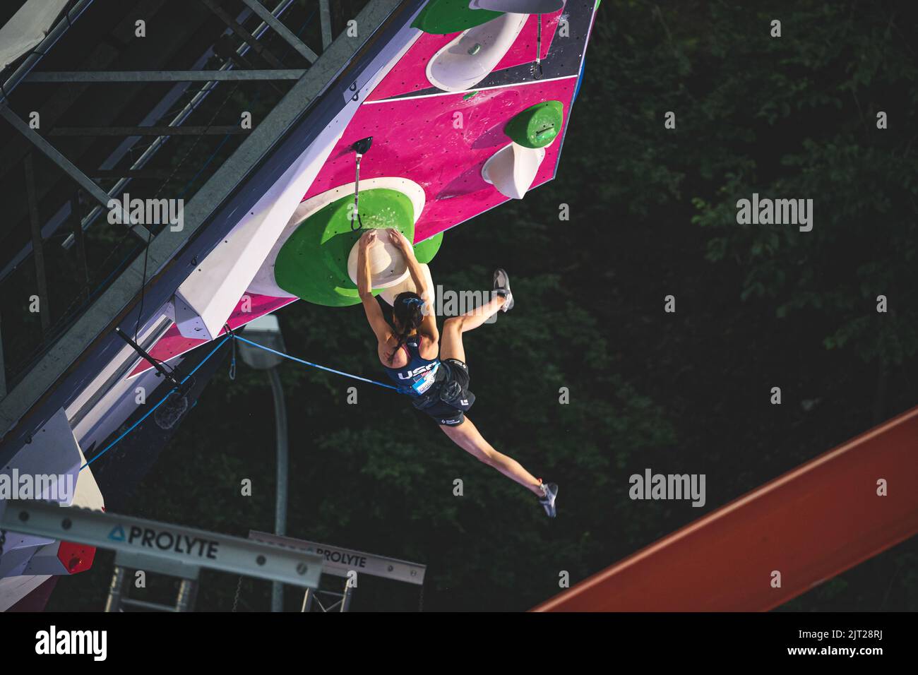 An athlete jumping on the final route of the IFSC lead world cup Stock Photo